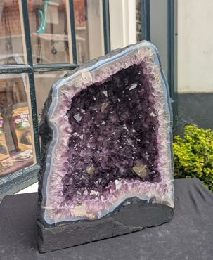 Extra ruwe Amethist Geode  middenmaat met donkerpaarse grotere en kleinere kristallen